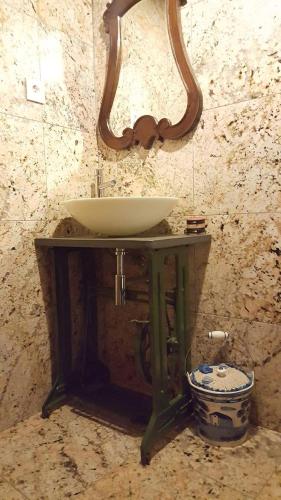 a sink on a wooden stand in a bathroom at Cantinho Ti Carlos in Pitões das Júnias