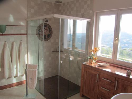 a bathroom with a shower with a glass shower stall at Villa Camporosso in Camporosso