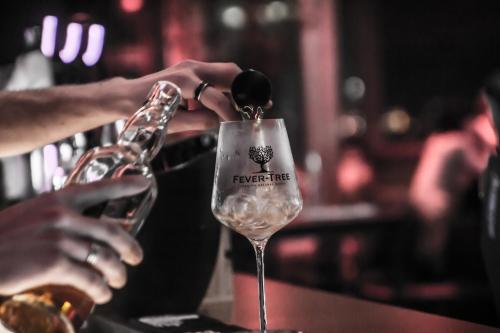 a person pouring wine into a wine glass at Hotel Schwarzer Bär in Linz