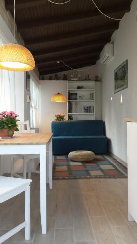 a living room with a blue couch and a table at Villa Vittoria in Citta' Sant'Angelo