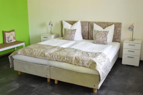 a bedroom with a large bed with white sheets and pillows at Landhotel Gillenfelder Hof in Gillenfeld