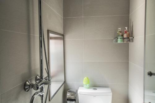 a bathroom with a shower with a toilet and a sink at Han Xuan Boutique Hostel in Hangzhou