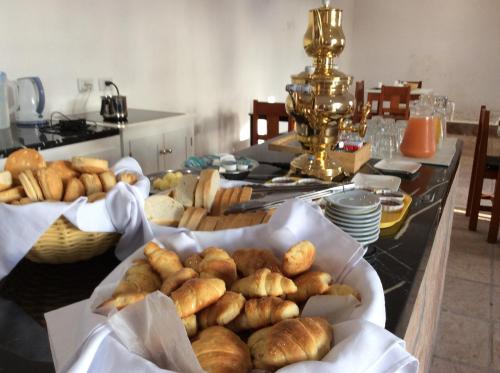 a table topped with lots of different types of bread at La Ramada in Cafayate
