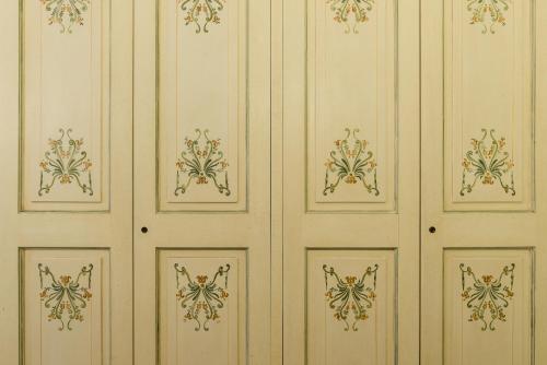 a white wall with gold designs on it at Hotel Donatello in Florence