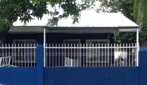 a blue fence in front of a blue house at Angeles City Guesthouse in Angeles