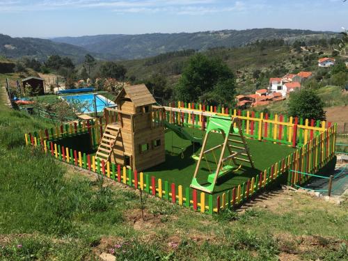 a playground with a slide and a play structure at Ecofurtado in Furtado