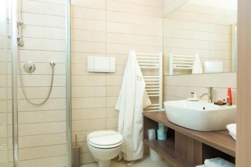 a bathroom with a toilet and a sink at Helios Hotel in Monza