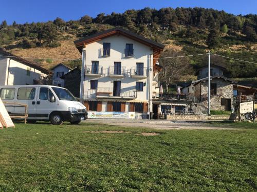 a white van parked in front of a house at Baita Dal Vikingo in Sorico