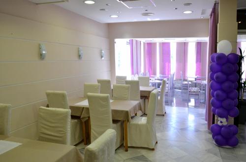 a dining room with white tables and purple balloons at Motel New Sanatron in Bosanski Novi
