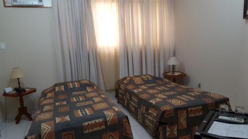 מיטה או מיטות בחדר ב-Fenícia Palace Hotel