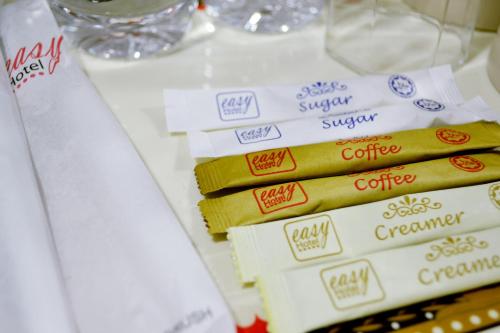 a stack of different types of coffee packets on a table at ESSY Hotel KL Sentral in Kuala Lumpur
