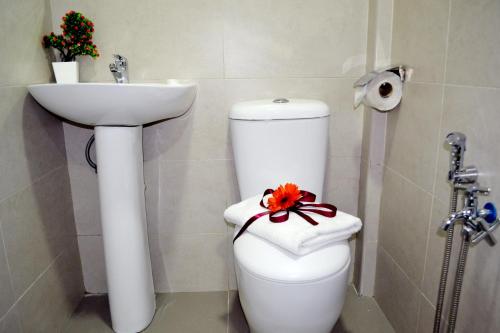 a bathroom with a white toilet and a sink at ESSY Hotel KL Sentral in Kuala Lumpur