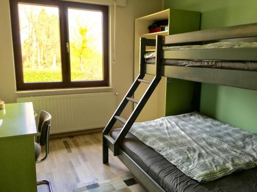 a bunk bed in a room with a window at Eifelhaus Emmels in Saint-Vith