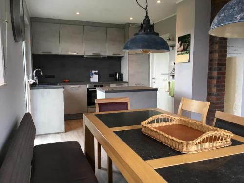 a kitchen with a table with a basket on it at Eifelhaus Emmels in Saint-Vith