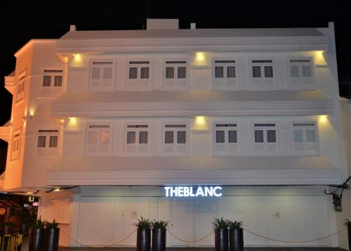 a white building with the king sign on it at TheBlanc Boutique Hotel in Melaka