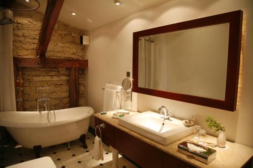 a bathroom with a tub and a sink and a bath tub at Pädaste Manor in Pädaste