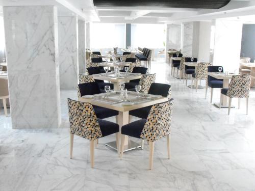 a dining room with tables and chairs and marble floors at Tolip El Galaa Hotel Cairo in Cairo
