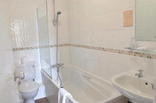 a white bathroom with a toilet and a sink at Lincombe Hall Hotel & Spa - Just for Adults in Torquay