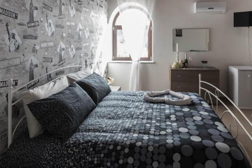 a bedroom with a bed and a wall with pictures at Tenuta Ferrara in Altavilla Silentina