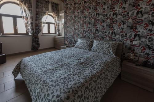 a bedroom with a bed with a patterned wall at Tenuta Ferrara in Altavilla Silentina