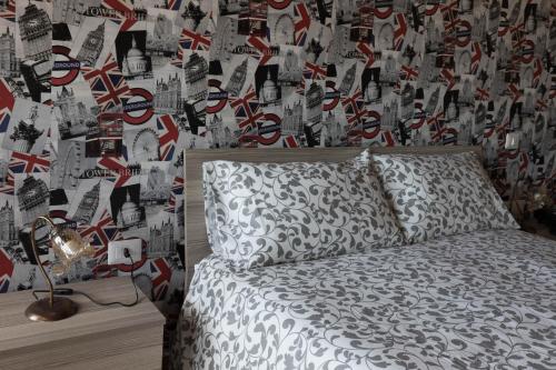 a bedroom with a bed and a wall with british flags at Tenuta Ferrara in Altavilla Silentina