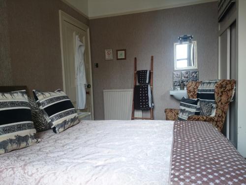 a bedroom with a large bed and a window at Albert Hotel in Peterhead