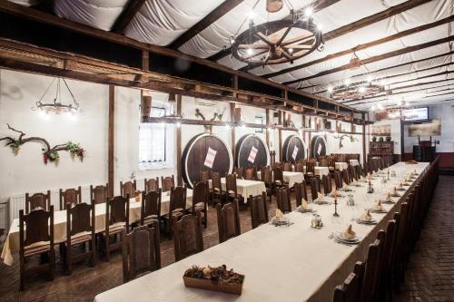 a large room with a long table and chairs at Hotel Stari Podrum in Ilok