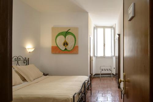 a bedroom with two beds and a painting on the wall at Hotel Porta Marmorea in Gubbio