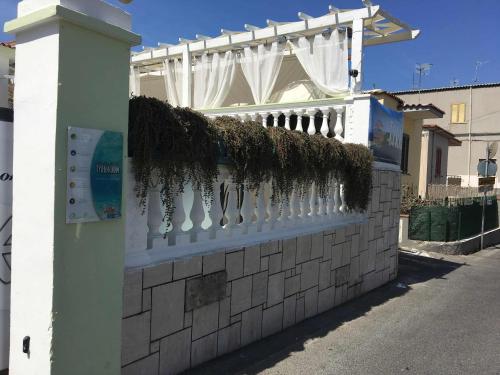 a white fence with plants on the side of a street at Residence R&B Tyrrhenum in Monte di Procida