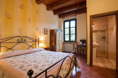 a bedroom with a bed and a bathroom at Agriturismo Val in Costermano sul Garda