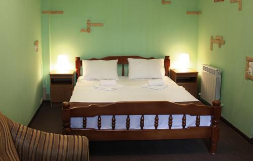 a bedroom with a large bed with two night stands at Buhta Udachi Mini-hotel in Gelendzhik