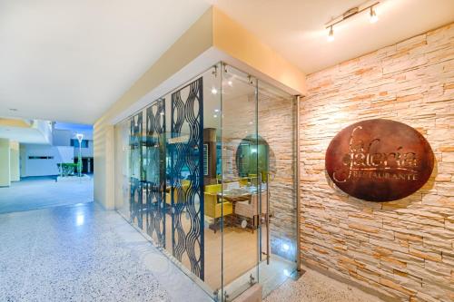 a lobby with a brick wall and a display case at Hotel Arizona Suites Cúcuta in Cúcuta