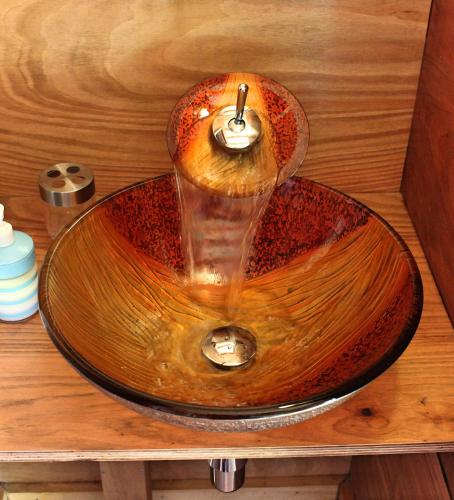 a wooden sink with a faucet in a bathroom at Hostal Boutique Los Arrayanes in Castro