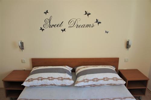 a bedroom with a bed with a word and stars on the wall at Apartment Prancic in Nečujam