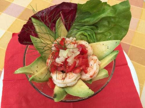 a bowl of food with shrimp and vegetables on a table at Hotel Concordia in Porlezza