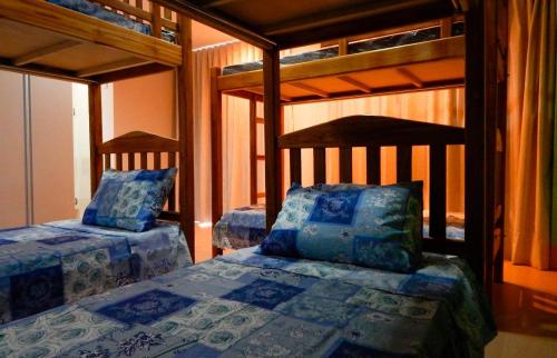 a bedroom with two bunk beds in a room at Dom Bosco Hostel in Cuiabá