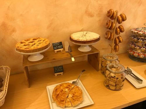 a table with pies and other baked goods on display at Hotel Villa Merope in Rimini
