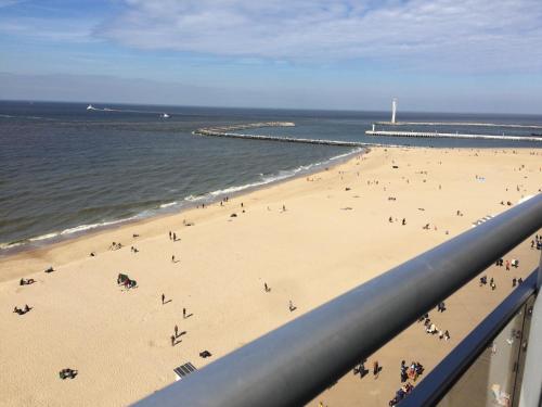
a beach with a large group of people on it at appartement seafront in Ostend
