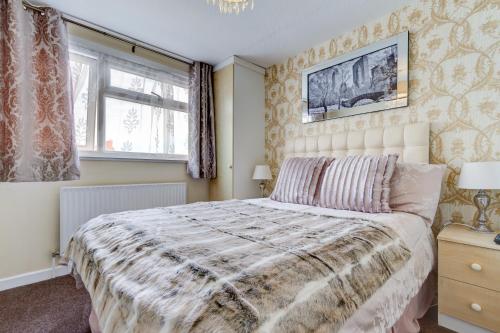 a bedroom with a large bed and a window at Beachcliffe Holiday Apartments in Blackpool