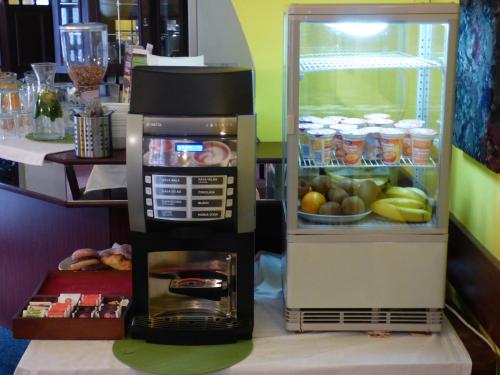 a coffee maker is sitting next to a refrigerator at Penzion - Restaurant U Zámku in Bečov nad Teplou