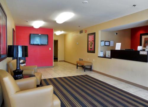 a waiting room with chairs and a flat screen tv at Extended Stay America Suites - San Antonio - Colonnade - Medical in San Antonio