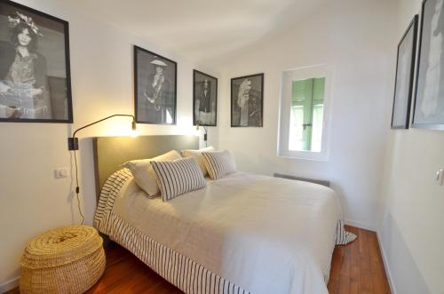 a bedroom with a large white bed with two pillows at Villefranche Sur Mer One Bed in Villefranche-sur-Mer