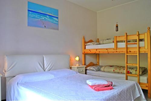 a bedroom with two beds and a bunk bed at B&B Marienn in Gavardo