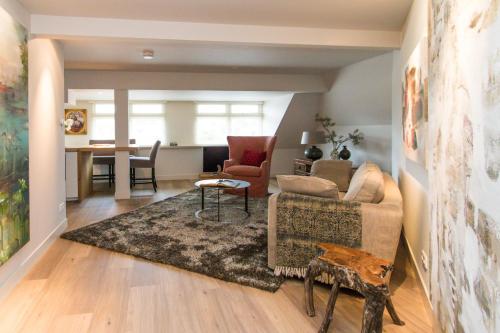 a living room with a couch and a table at Short stay Midden Drenthe in Beilen