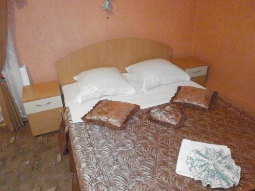 a bed with pillows on it in a room at Economy Hotel Fiesta in Izmail