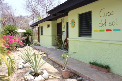 a house with a sign on the side of it at Casa del Sol Bed and Breakfast in Contadora