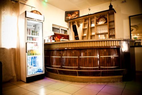 a bar in a restaurant with a refrigerator at Victoria Hotel in Jerusalem