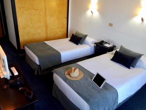 Postel nebo postele na pokoji v ubytování Hotel Miramar