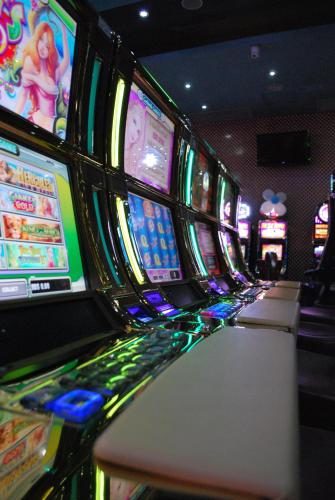 a row of slot machines in a casino at Platino Hotel & Casino in Santiago de los Caballeros