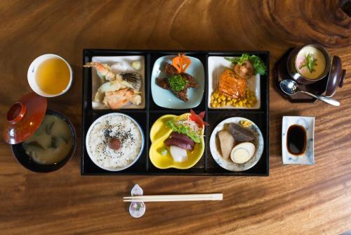 a tray of food on a wooden table with food at Microtel by Wyndham South Forbes near Nuvali in Santa Rosa